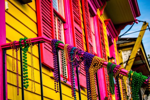 A colorful house bedecked in Mardi Gras beads.