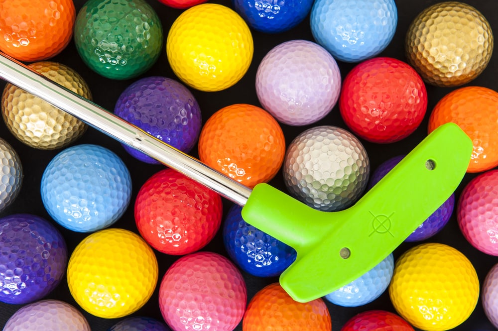 colorful-golf-balls-and-putter