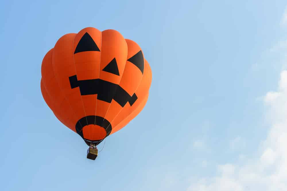 Jack-o-Lantern hot-air balloon in the sky.